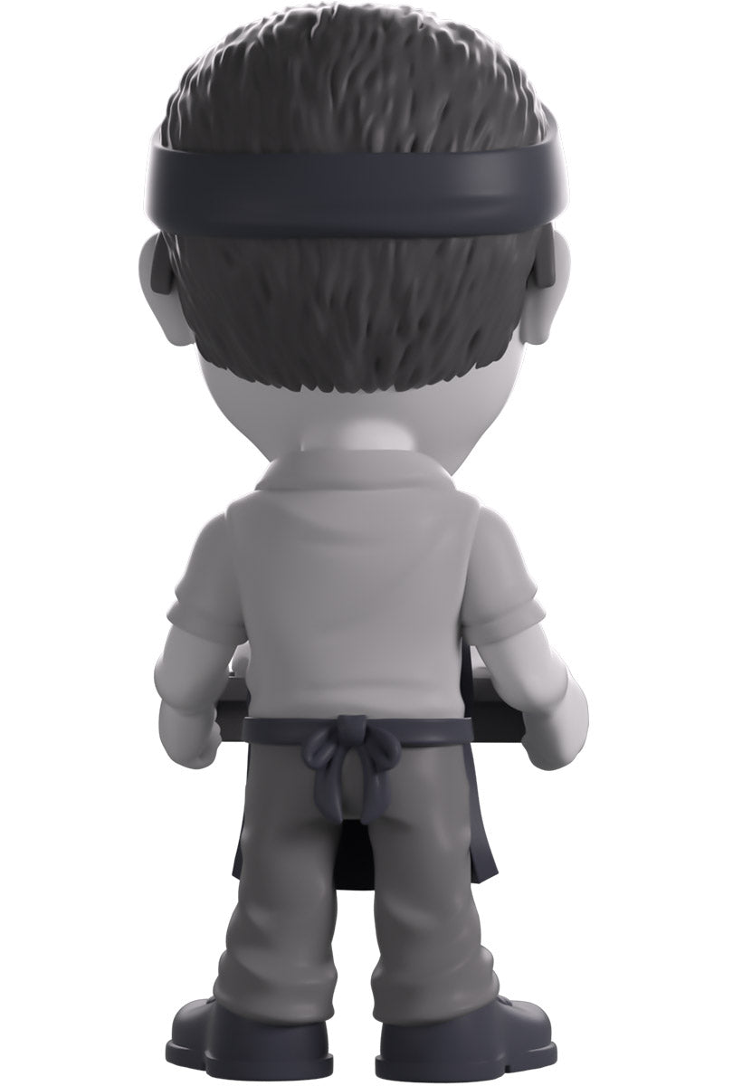Back view of a vinyl figure of Gene Takavic from 'YouTooz' holding a tray.