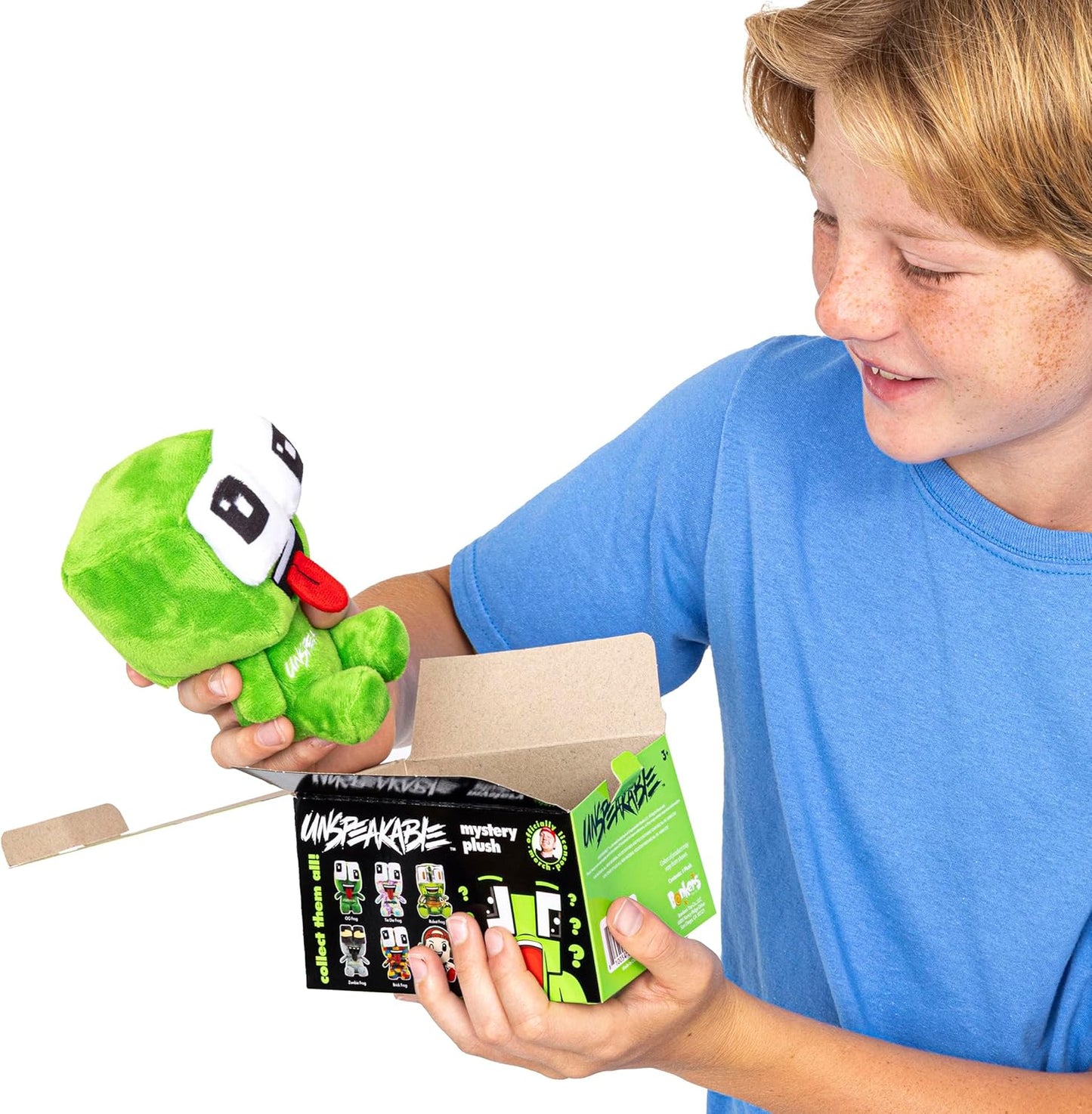 Child holding a green plush toy and its packaging with a white background