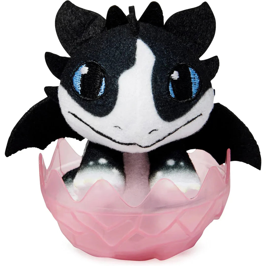 Plush toy with black and white design in a pink egg on a white background