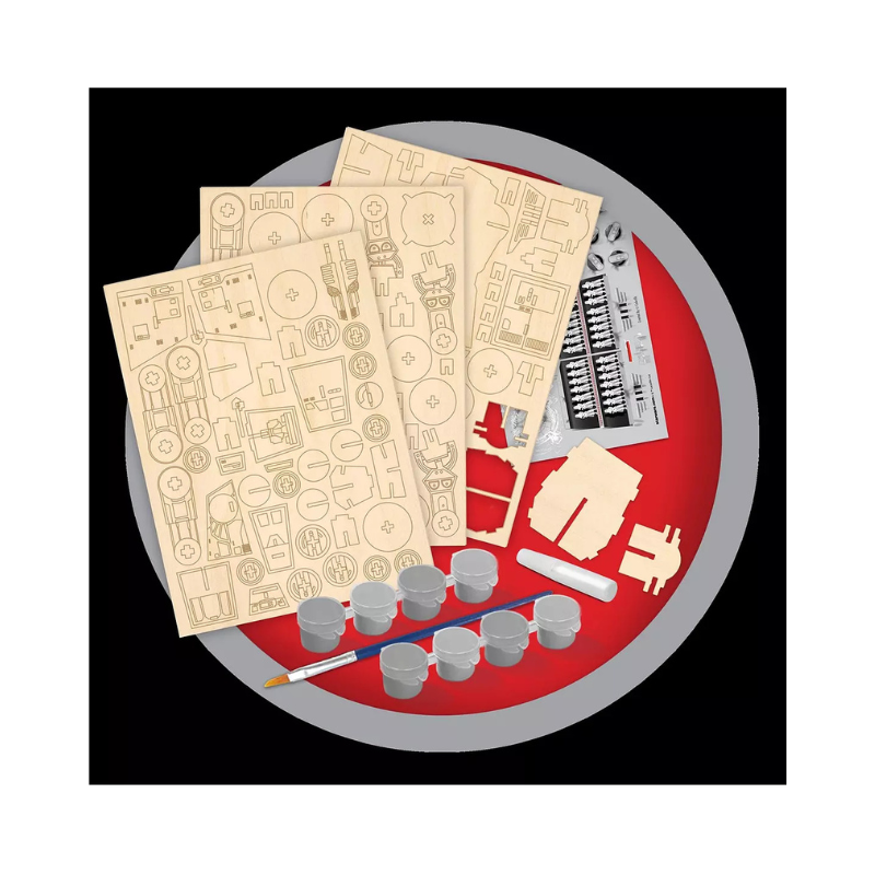 Model building kit with paper templates, plastic parts, and tools on a red and gray background