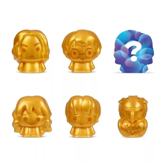 Set of gold figurines with a blue and purple question mark symbol on a white background