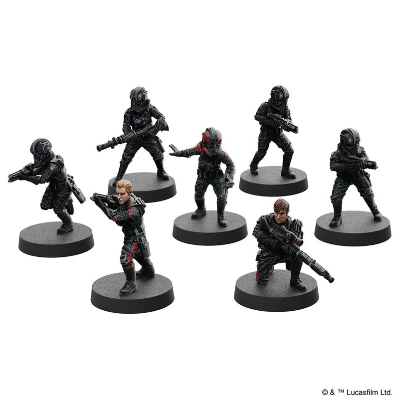 Set of six miniature figures on stands against a white background