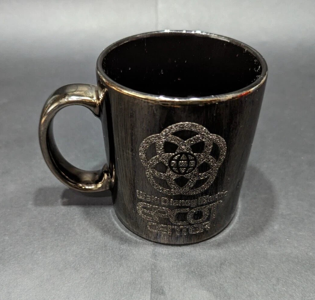 Rare 1980s Walt Disney World Epcot Center smoked chrome mug. Vintage collectible for Disney fans and coffee lovers. Shop now at New, Used and More!