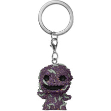 Purple glittery keychain with a character design on a white background