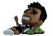 YouTooz Boxed vinyl figure of Vikkstar123. A soccer player with a black and white striped shirt on a white background