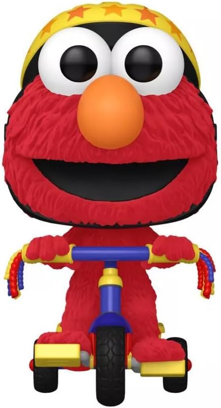 Elmo figurine on a tricycle with a yellow hat and orange nose, from Sesame Street.