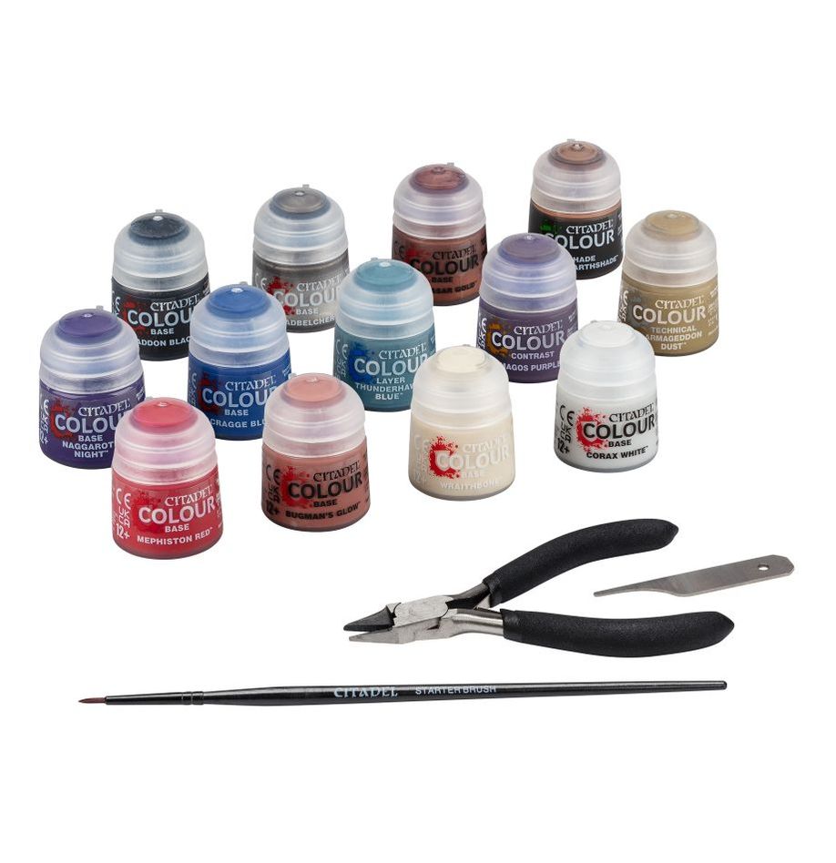 Collection of Citadel Colour paint pots and painting tools on a white background