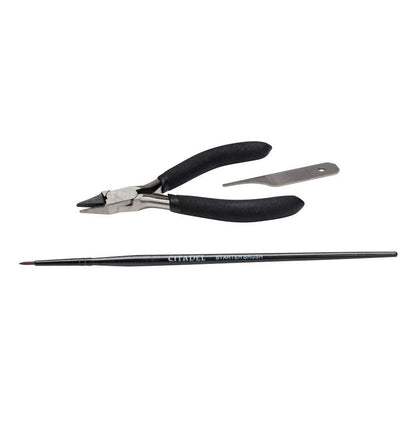 Pair of pliers with black handles and a brush on a white background