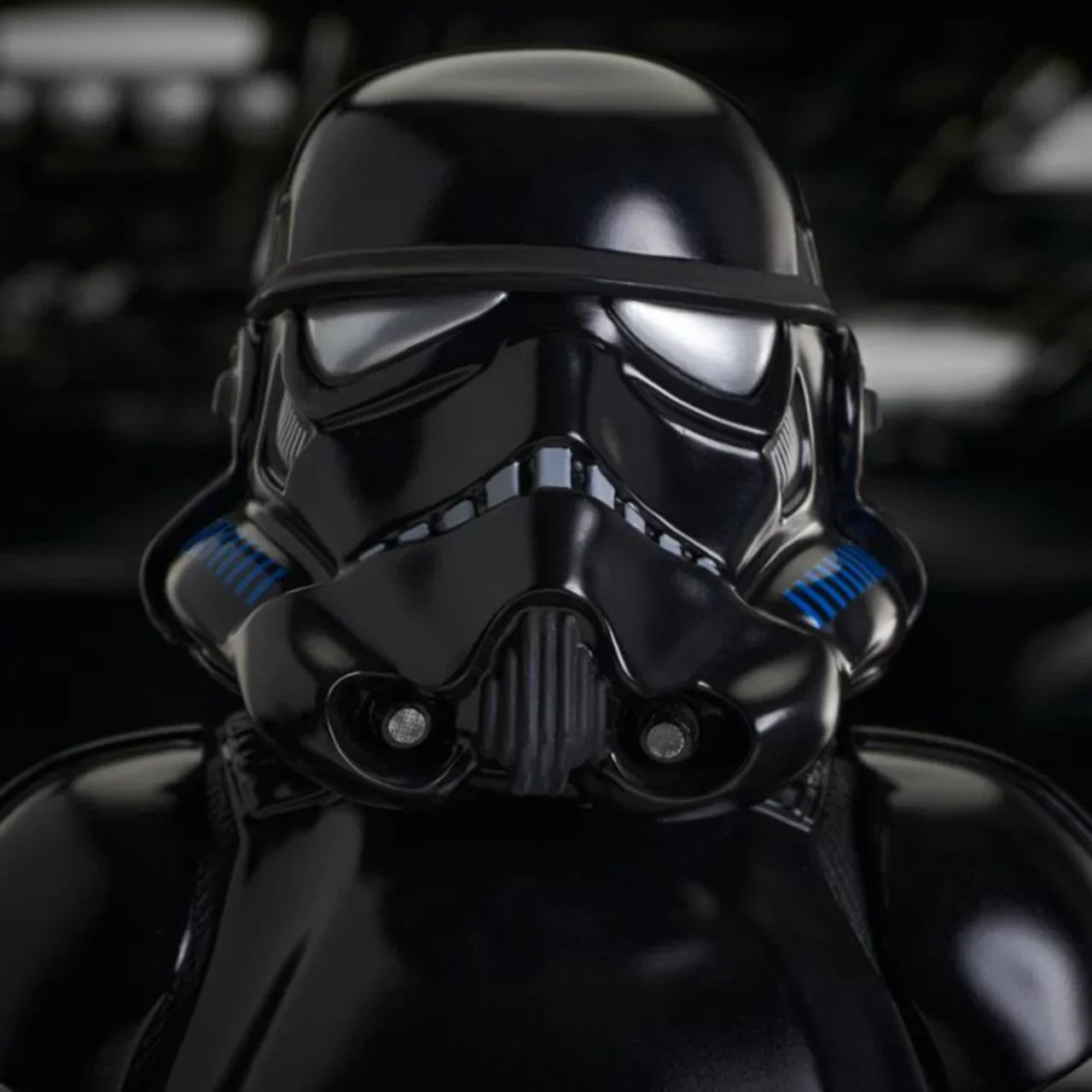 Black stormtrooper helmet with blue accents on a dark background