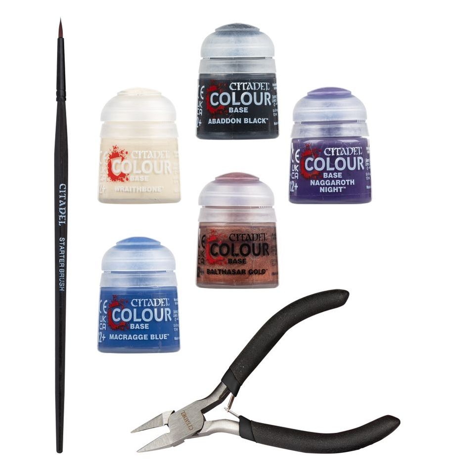 Collection of Citadel Colour paint jars and a brush on a white background