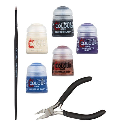 Collection of Citadel Colour paint jars and a brush on a white background