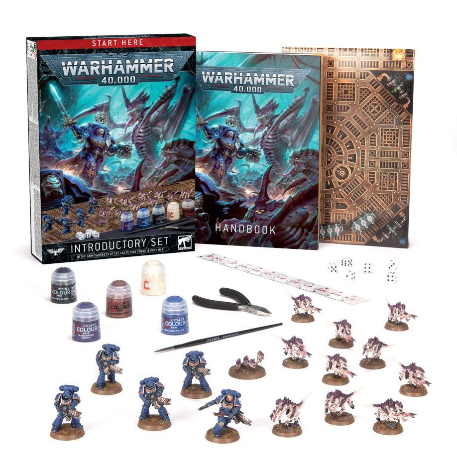 Warhammer 40,000 game set with miniatures, models, and rulebooks on a white background
