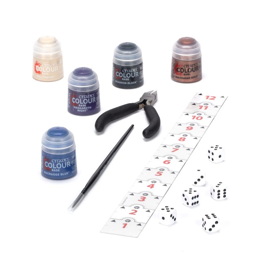 Set of Citadel Colour miniatures paint pots, a brush, pliers, and dice on a white background