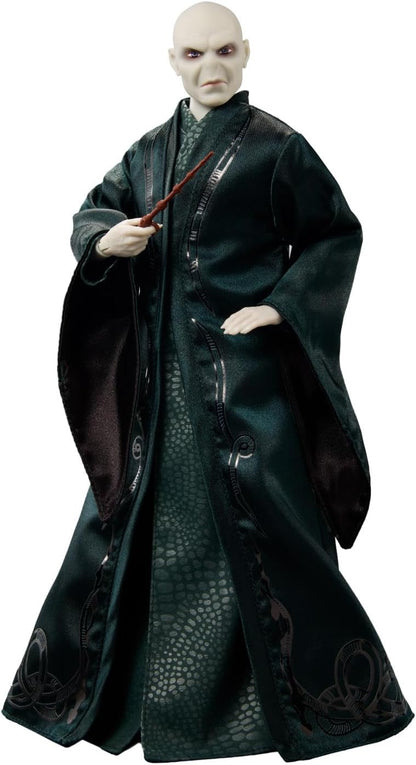 Voldermort figure in dark robe with snake pattern holding a wand on a white background