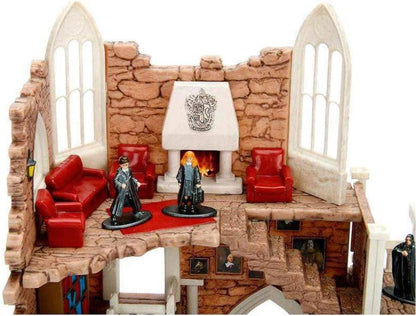 Toy living room set with furniture and figures on a white background