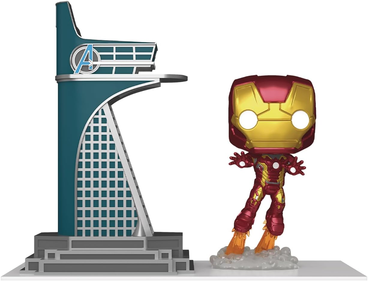 Iron Man figure standing next to a model of the Avengers Tower on a white background