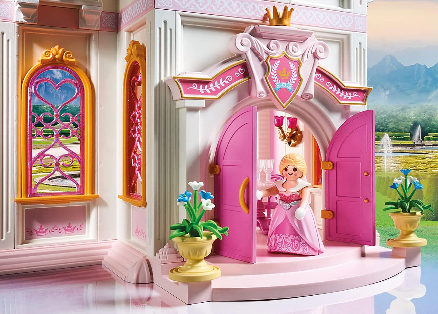 Toy castle with a princess doll inside, set against a scenic background.