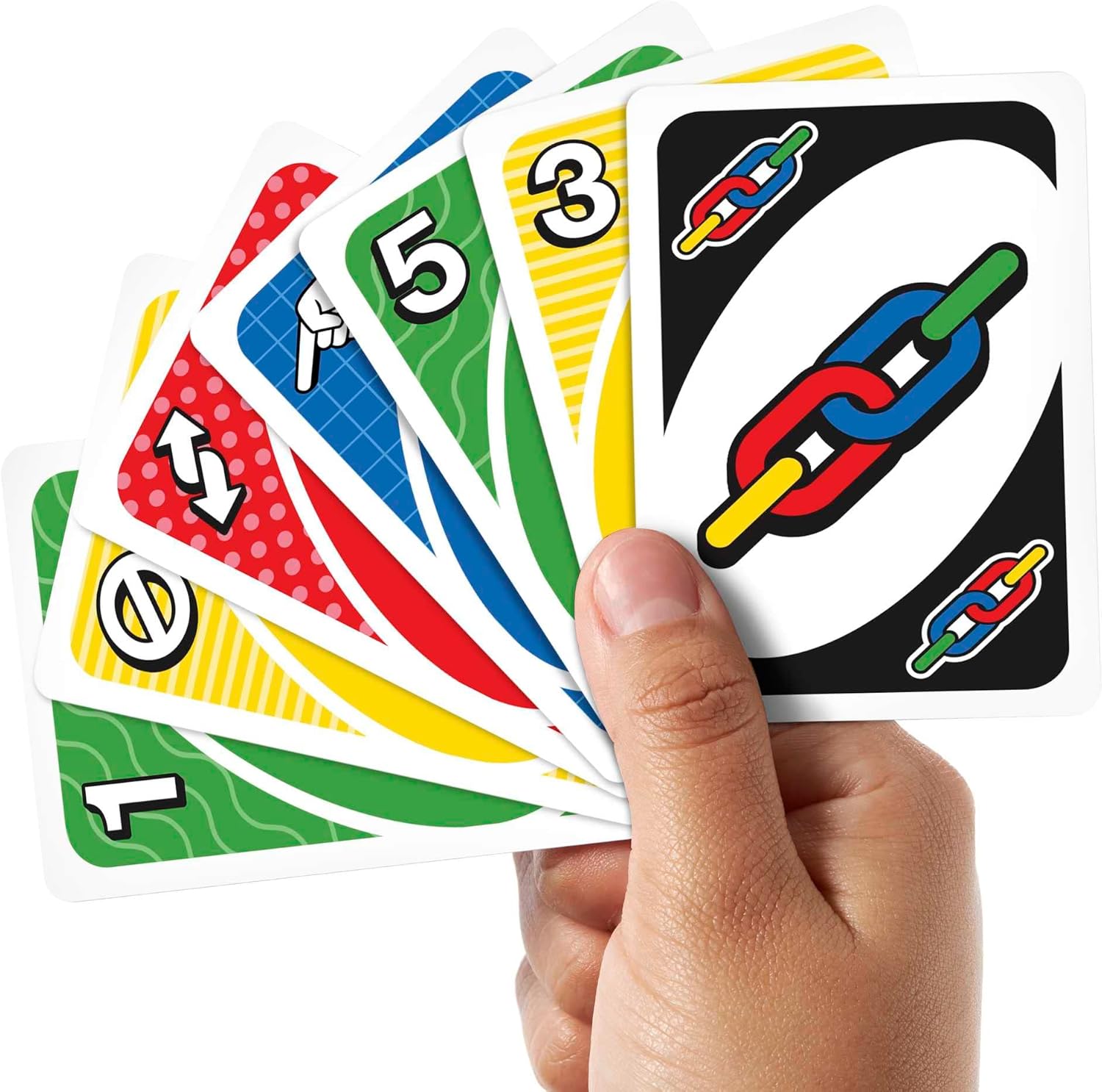 Hand holding a set of colorful card games with various symbols on a white background