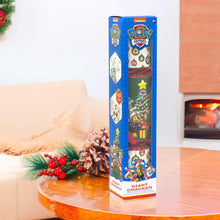 PAW Patrol Giant Cracker box on a table with festive decorations and a fireplace in the background