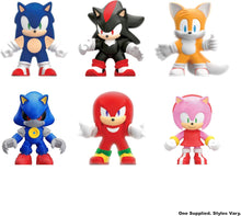 Set of six colorful cartoon character figurines on a white background