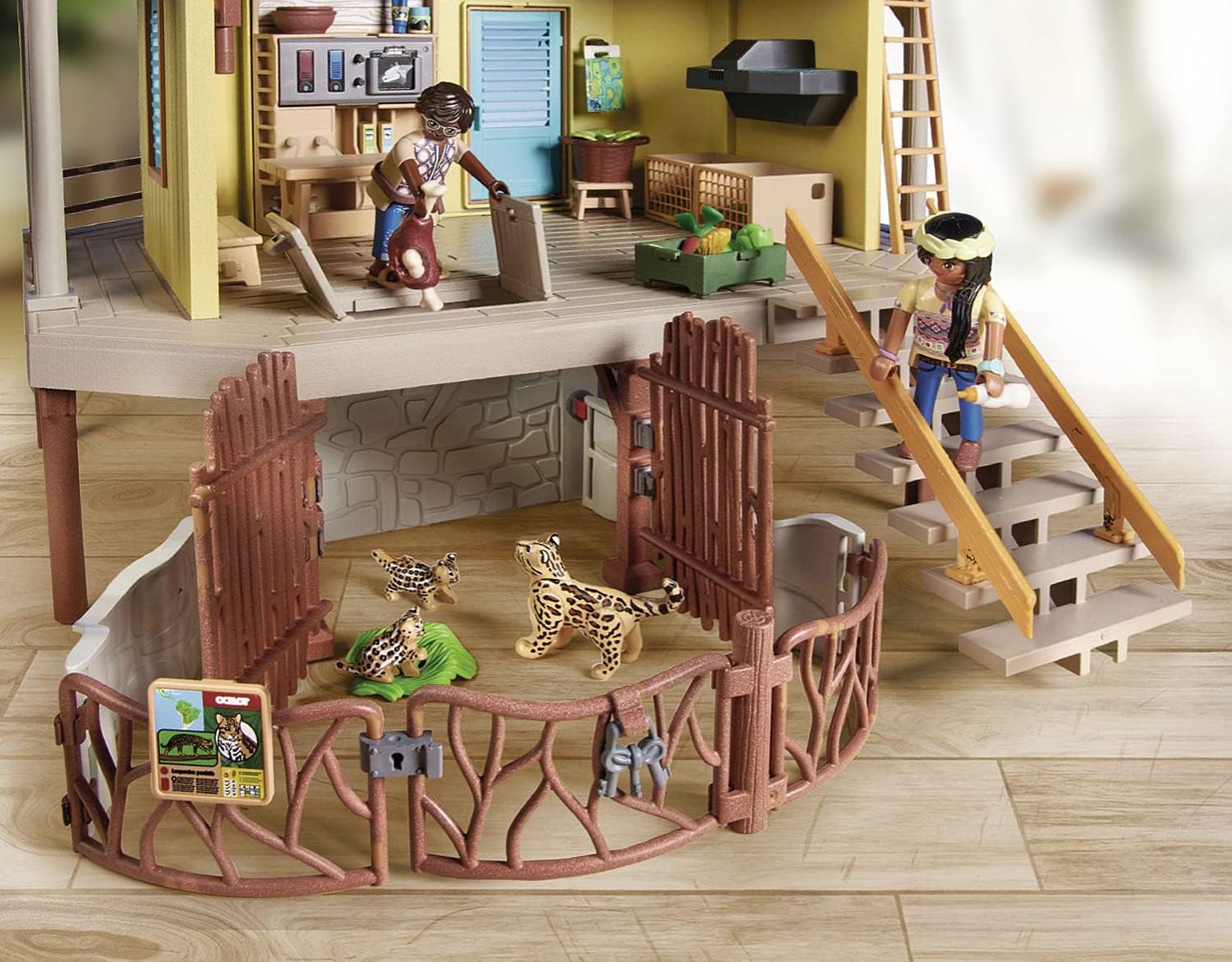 Toy playset with animals and people on a wooden floor