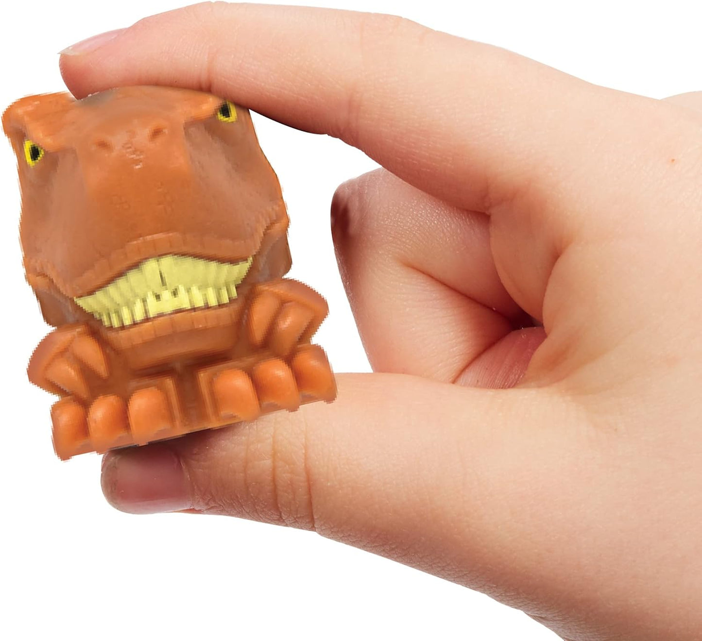 Hand holding a small dinosaur-shaped stress reliever toy against a white background