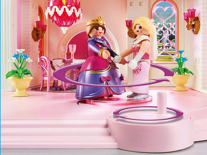 Playmobil princess figures in a decorated room with furniture and decor.