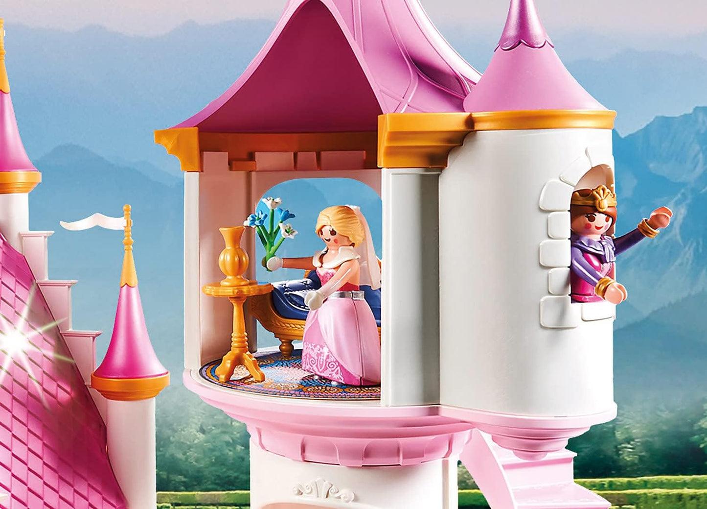 Playmobil princess castle with two dolls in front of a scenic background