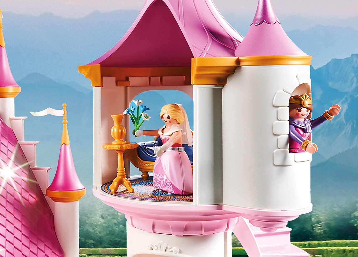 Playmobil princess castle with two dolls in front of a scenic background