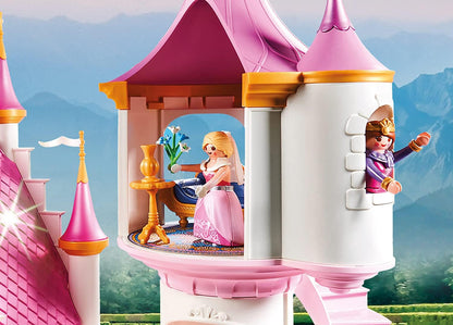 Playmobil princess castle with two dolls in front of a scenic background