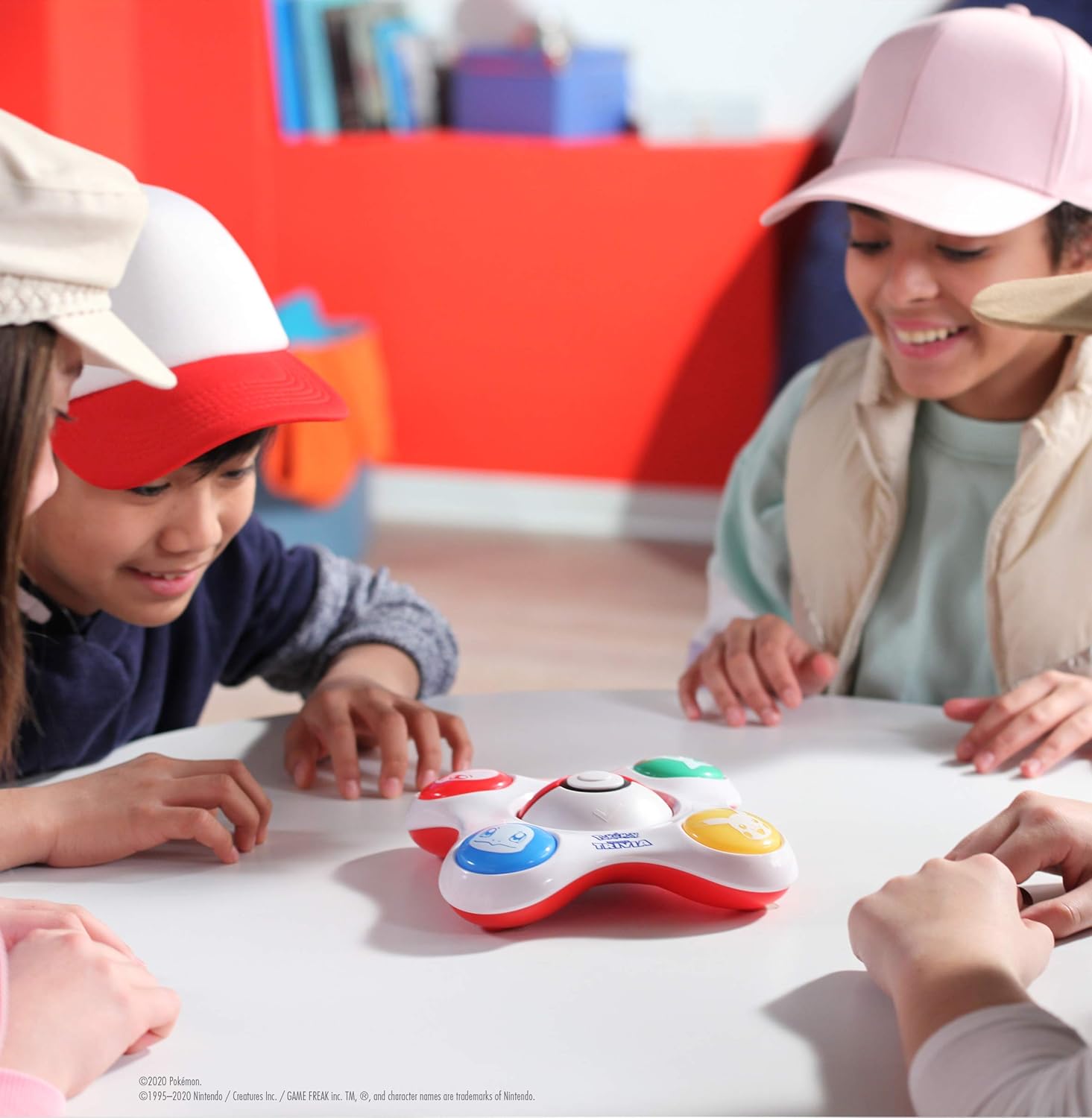 Children playing with a toy on a table in a classroom setting