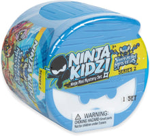 Toy packaging for 'Ninja Kidzi! Shadow Masters' with blue lid and colorful design.
