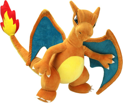 Plush toy of a Pokemon Charizard creature with blue wings and red flame on a white background