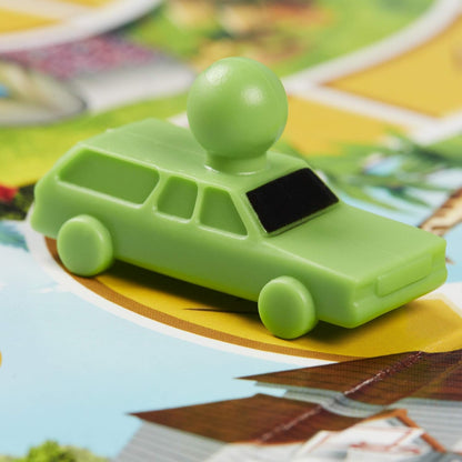 Green toy car with a ball on top on a colorful surface