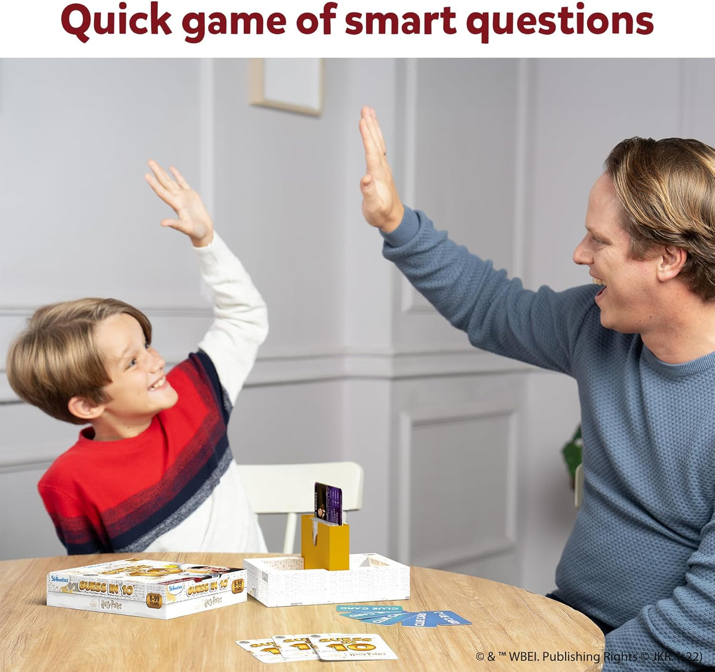 Man and child playing a card game together with text 'Quick game of smart questions'.