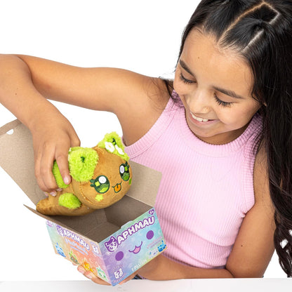 Child holding an Aphmau plush toy with a cardboard box featuring a brand logo.