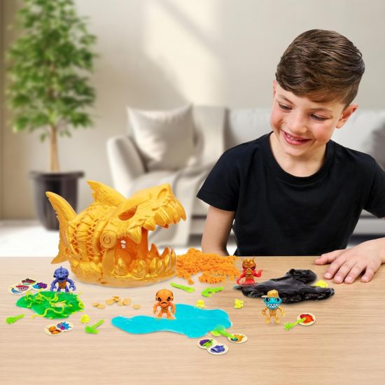 Child playing with a toy set on a table, including a large yellow dragon-like creature and various small figures.