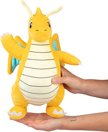Dragonite Plush toy resembling a dragon-like creature held by a person on a white background