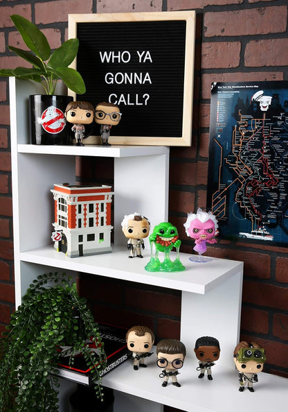 White shelf with Funko Pop! figures and a letterboard against a brick wall.