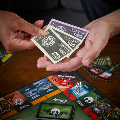 Hands holding Monopoly property cards with a game board in the background