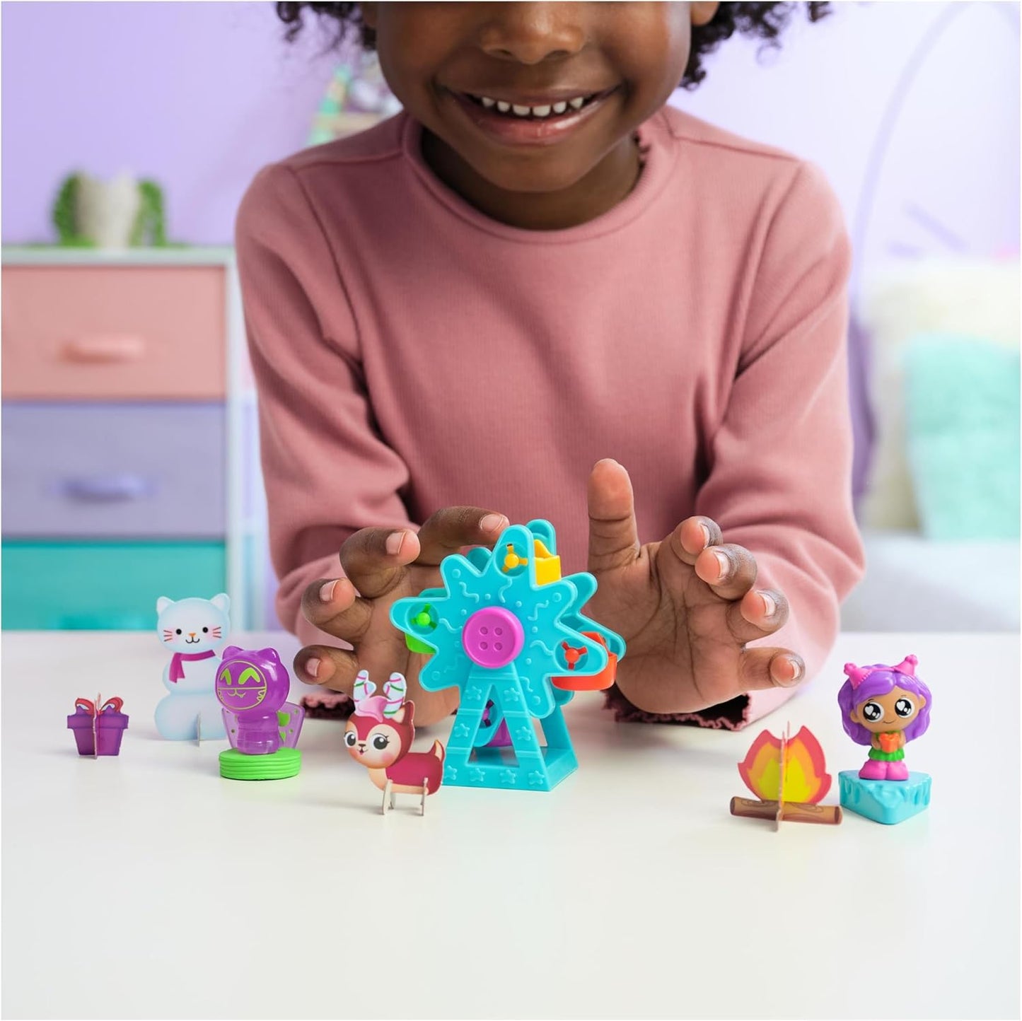 Child playing with colorful toy figures on a table