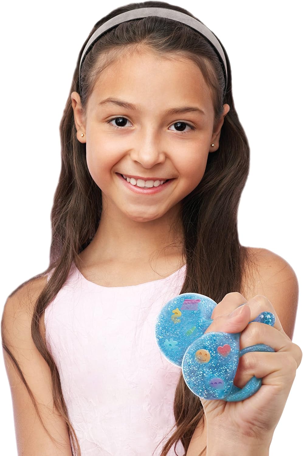 Young girl holding blue space-themed objects against a white background