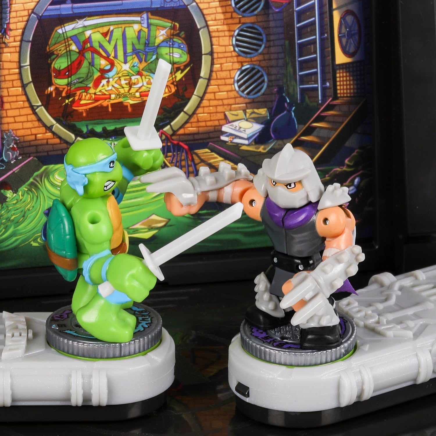 Two toy TMNT figures in front of a colorful backdrop with 'Teenage Mutant Ninja Turtles' branding.
