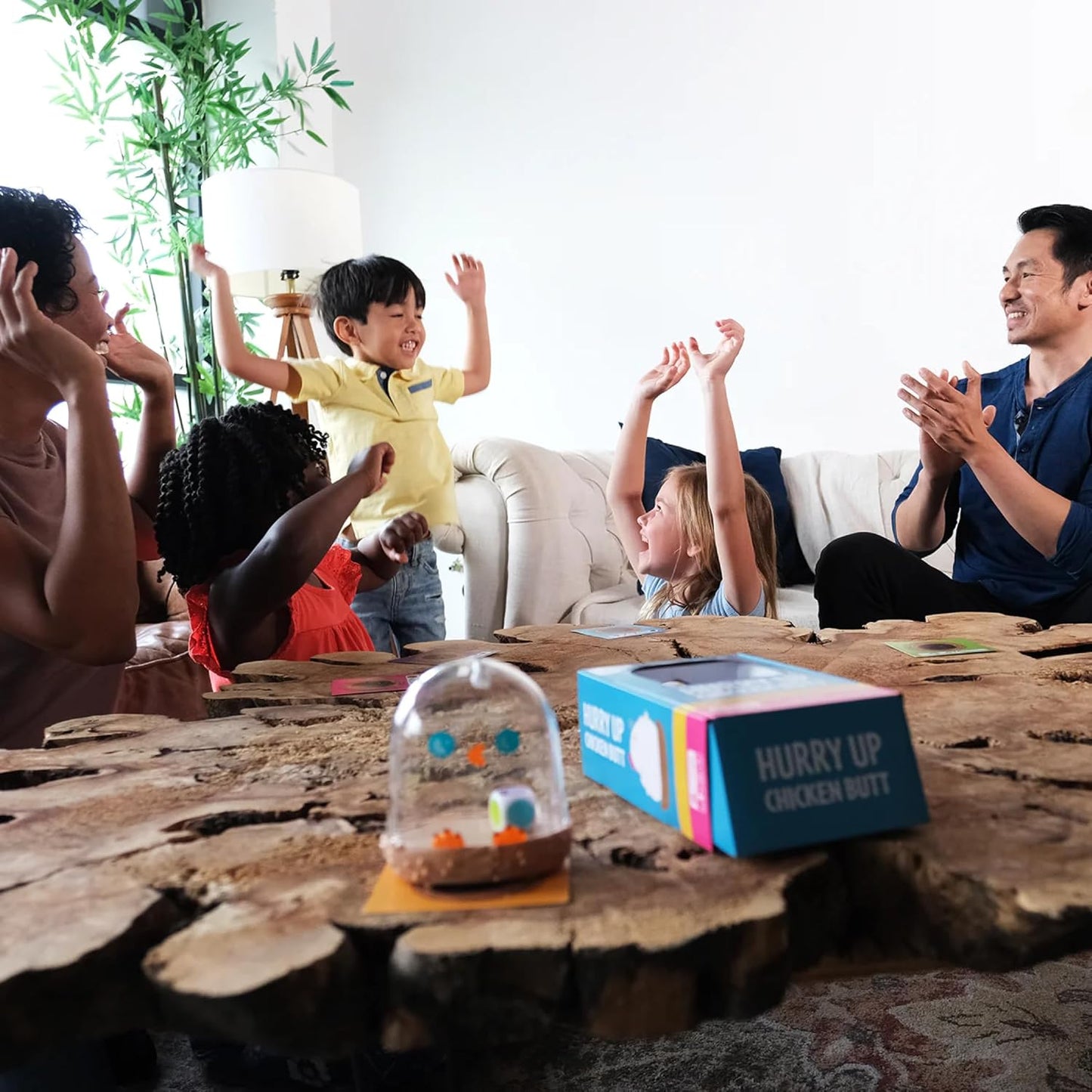Family playing a board game together in a living room