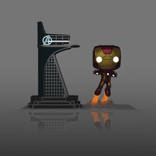 Iron Man pop vinyl figure standing next to a model of the Burj Al Arab hotel.