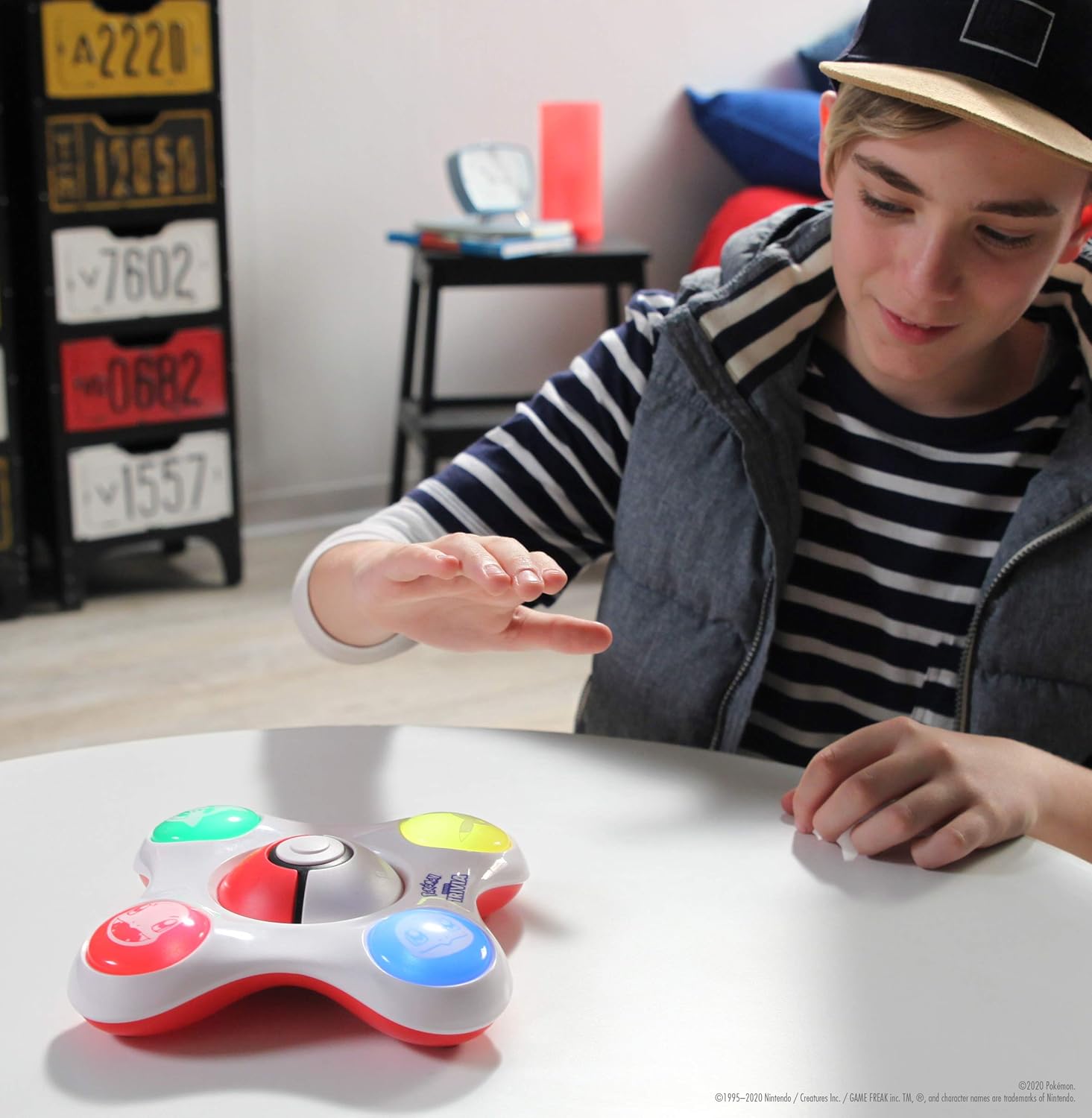 Person interacting with a trivia game on a table.