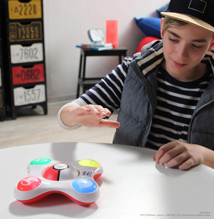 Person interacting with a trivia game on a table.