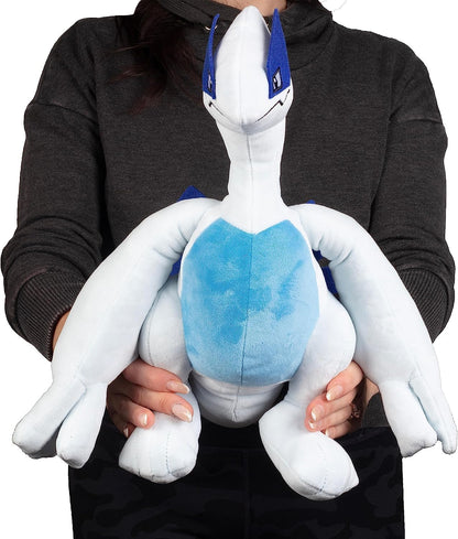 Person holding a large white and blue plush toy with blue accents