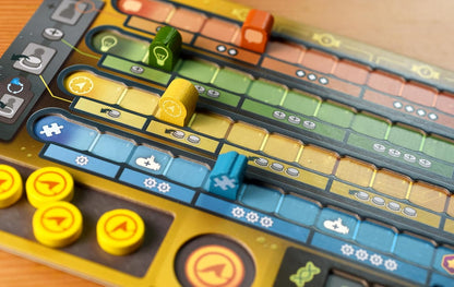 Close-up of a colorful board game with various pieces and tracks.