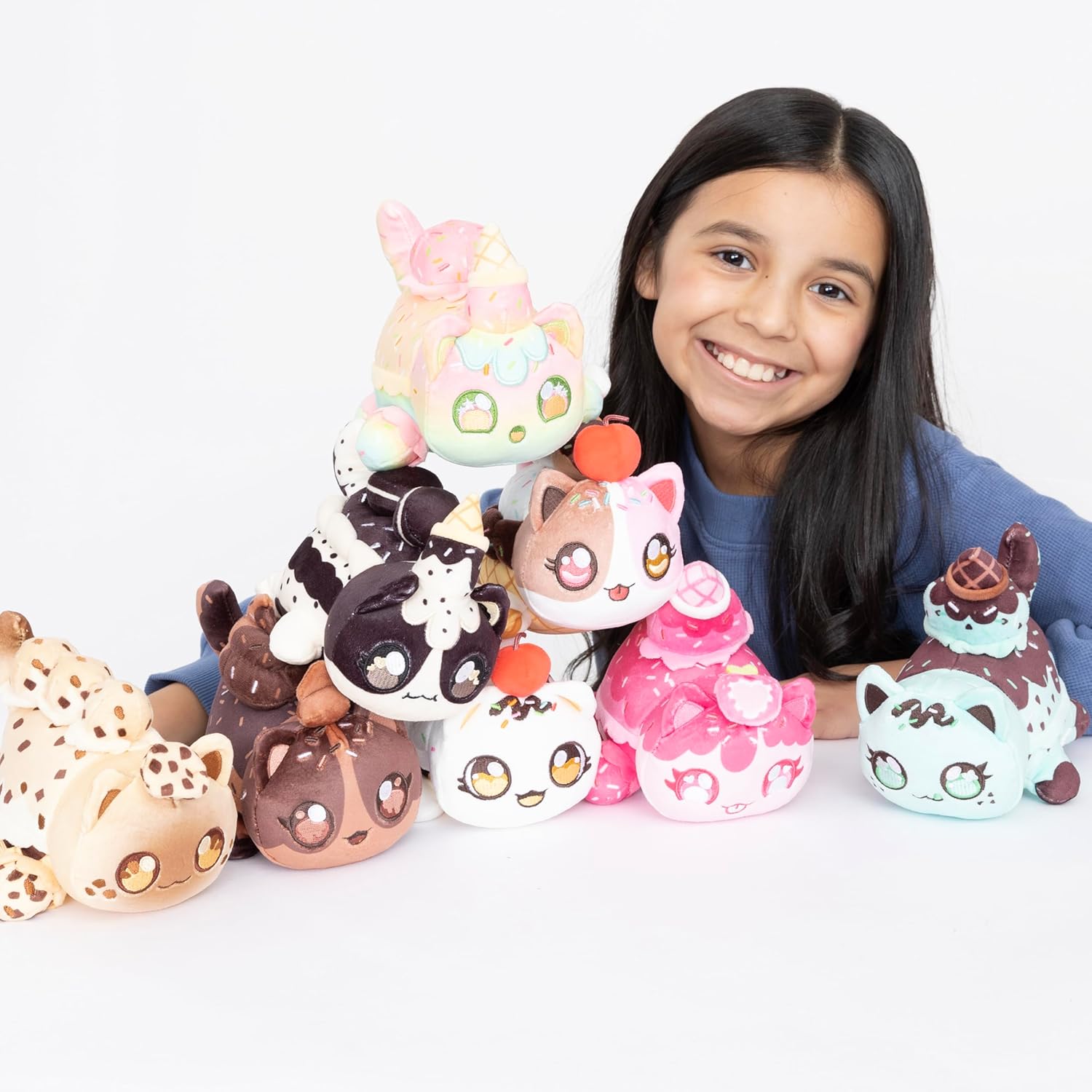 Girl with colorful animal-themed plush toys on a white background